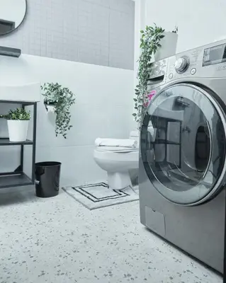 a bathroom with a washing machine and a toilet at Spacious Design Loft with Rooftop in Bangkok