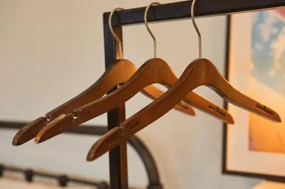 a group of wooden hangers hanging from a rack at Spacious Design Loft with Rooftop in Bangkok