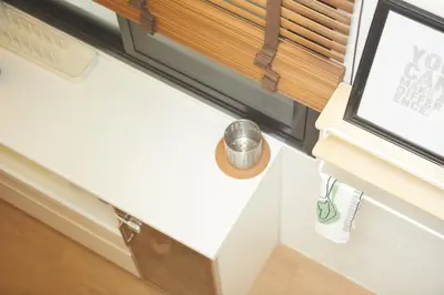 a room with a window with a cup on a window sill at Spacious Design Loft with Rooftop in Bangkok