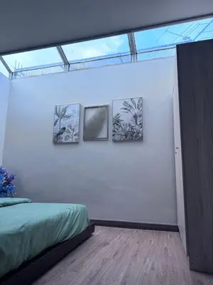a bedroom with three pictures on a wall with a bed at Bud Brew Beyond Dispensary and Hotel in Bangkok