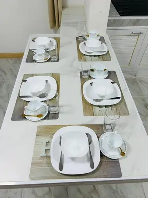 a table with white plates and glasses on it at 93 House in Ban Bang Toei (1)