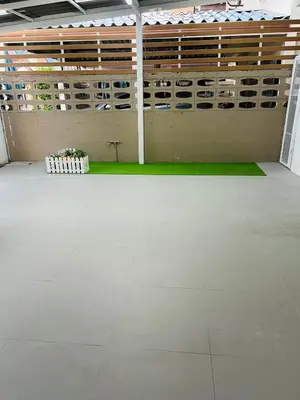 a large room with a white floor and a wall with empty shelves at 93 House in Ban Bang Toei (1)