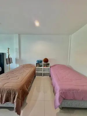 two beds sitting next to each other in a room at Baan Farang in Bangkok