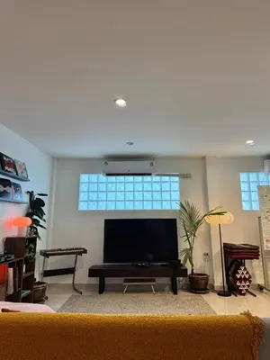 a living room with a large flat screen tv at Baan Farang in Bangkok