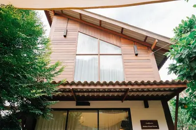 a house with a window and a roof at Baanrongmai Canal Front Homestay in Bang Chak