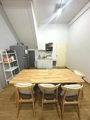 a room with a wooden table and two chairs at Bee House 172 only 300m to BTS Talat Phlu in Bangkok