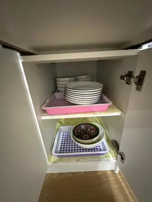 a cupboard with plates and dishes in it at Bee House 172 only 300m to BTS Talat Phlu in Bangkok