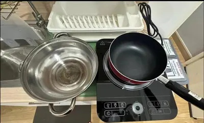 a pot on top of a mixer with a strainer at Bee House 172 only 300m to BTS Talat Phlu in Bangkok