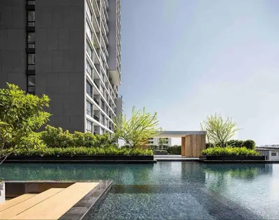 a swimming pool in front of a building at 1 Bedroom near MRT & BTS station. in Bangkok