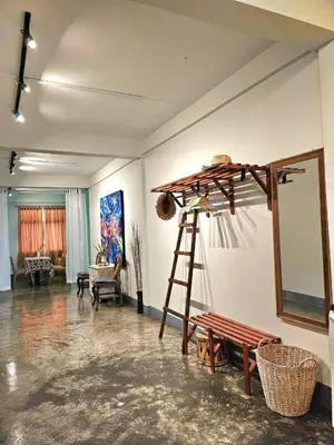 a room with a ladder and a mirror on a wall at Cozy Gallery Studio at Chinatown in Bangkok