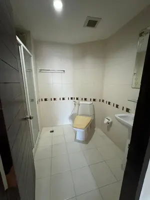 a bathroom with a toilet and a sink at Orchid Inn SKV3 in Bangkok