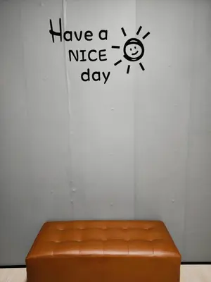 a brown leather bench in a room with a nice day sign at 201-Olan Place Homely room Free Wi-Fi and Near BTS line in Bangkok