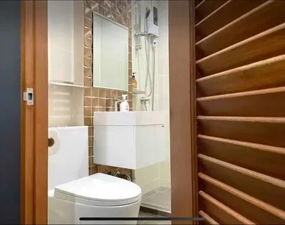 a bathroom with a white toilet and a mirror at Purple House King BR Walk to Grand Palace in Bangkok