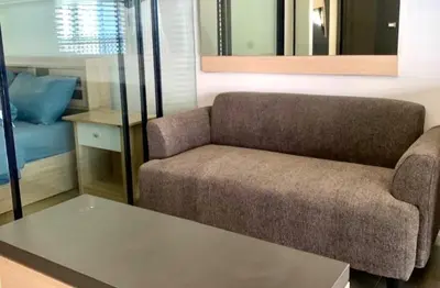 a living room with a couch and a table at Circle S Sukhumvit12 NearBTS,MRT in Bang Kapi