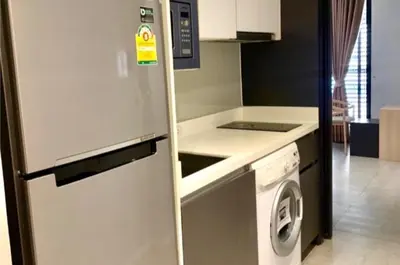 a kitchen with a refrigerator and a washing machine at Circle S Sukhumvit12 NearBTS,MRT in Bang Kapi