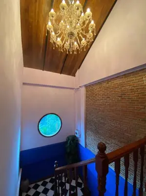 a staircase with a chandelier and a window at T-house 10 -6BR Max15ppl whole house with pool in Bangkok