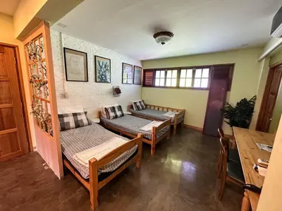 a room with three beds and a table at T-house 10 -6BR Max15ppl whole house with pool in Bangkok