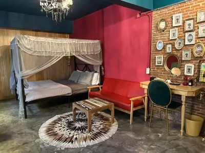 a bedroom with a bed and a table and a chair at T-house 10 -6BR Max15ppl whole house with pool in Bangkok