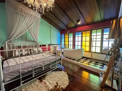 a bedroom with a large bed and a bath tub at T-house 10 -6BR Max15ppl whole house with pool in Bangkok