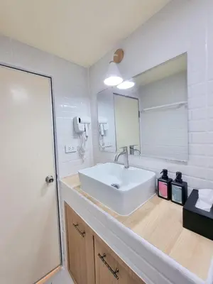a bathroom with a white sink and a mirror at ห้องพักเมืองทองธานี Happiness Sleep P1 in Ban Song Hong
