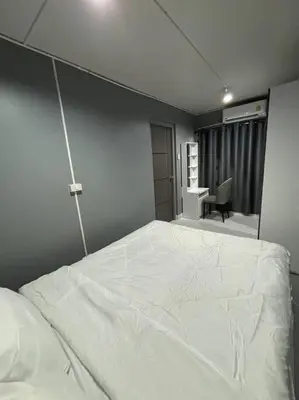 a bedroom with a large white bed in a room at Impact Donmuang Popular Condo C5 in Bangkok