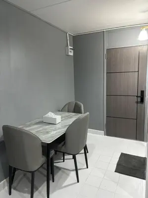 a dining room with a table and two chairs at Impact Donmuang Popular Condo C5 in Bangkok