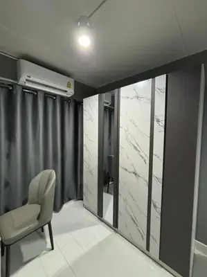 a room with a chair and a window at Impact Donmuang Popular Condo C5 in Bangkok