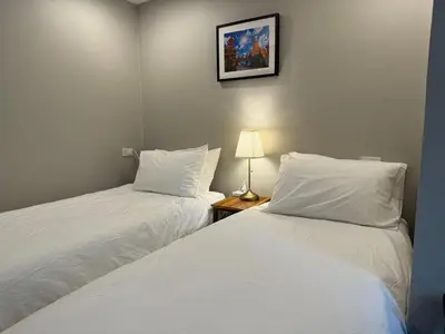 two beds sitting next to each other in a room at Rimm49 Bangkok in Bangkok