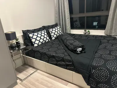 a bed with black and white pillows on it at Casa Bondia in Bangkok