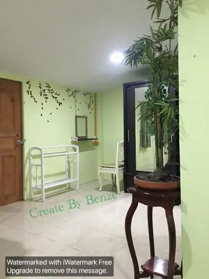 a room with a mirror and a table with a plant at GreenRoom Guest House Very Close Bangkok Hospital in Thailand in Bangkok