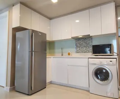a kitchen with a refrigerator and a washing machine at Condominium - Sukhumvit Soi 5 BTS Nana- Room Size 50m2 in Bangkok