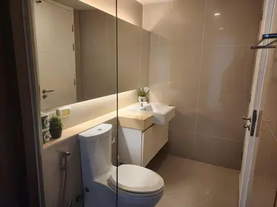 a bathroom with a toilet and a sink and a mirror at Condominium - Sukhumvit Soi 5 BTS Nana- Room Size 50m2 in Bangkok