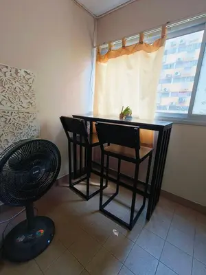 a black table and chairs in a room with a window at SimpleRoomDesign, VeryClose Impact Muaungthongthani in Thung Si Kan