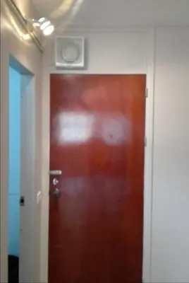 a brown door in a room with a white wall at SimpleRoomDesign, VeryClose Impact Muaungthongthani in Thung Si Kan