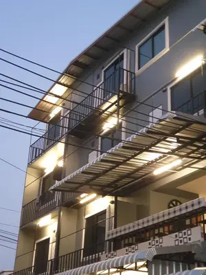a building with lights on the side of it at Gail's Hostels in Bangkok