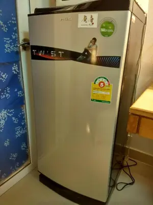 a silver refrigerator with a picture of a woman on it at Savi Rooms Premium 1 Near Bkk Piyavet Hospital in Bangkok