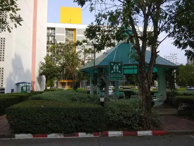 a small building with a sign in a park at Savi Rooms Premium 1 Near Bkk Piyavet Hospital in Bangkok