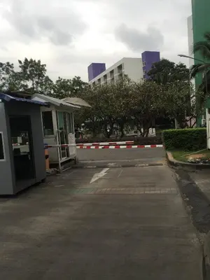 an empty parking lot with a building in the background at Savi Rooms Deluxe 3 Nr Bangkok piyavet Hospital in Bangkok