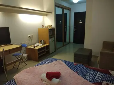 a bedroom with a bed with a stuffed animal on it at Savi Rooms Super Deluxe Studio 2 Nr Bkk Hospital in Bangkok