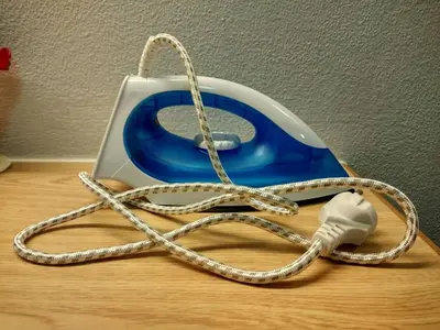a phone with a rope and a charger on a table at Savi Rooms Super Deluxe Studio 2 Nr Bkk Hospital in Bangkok