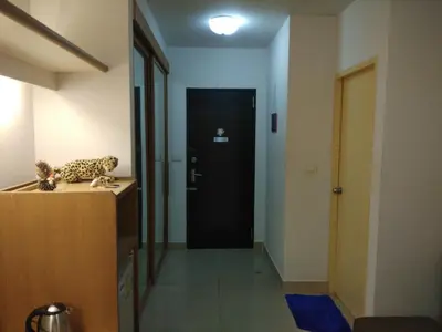 a hallway with a black door and a leopard toy on a counter at Savi Rooms Super Deluxe Studio 2 Nr Bkk Hospital in Bangkok