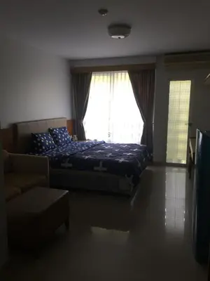 a bedroom with a bed and a couch and a window at Savi Rooms Premium studio near bkk Piyavet hospital near most famous pubs in Bangkok