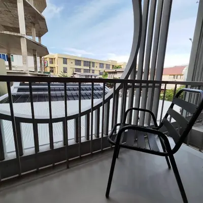 a chair on a balcony with a view of a street at ROOMS at Number60 Khaosan Bangkok in Bangkok
