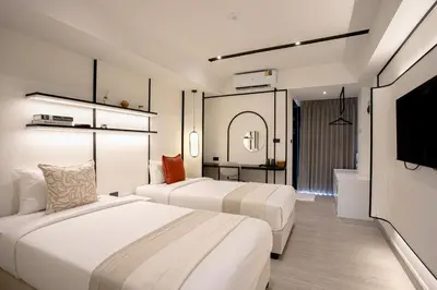 a hotel room with two beds and a bathroom at Pillow B Hotel in Ban Zong Katiam