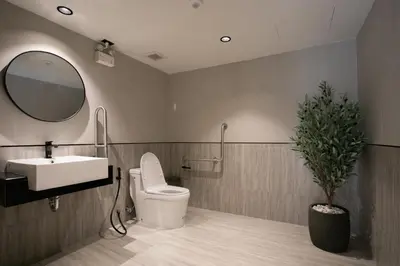 a bathroom with a sink and a toilet and a mirror at Pillow B Hotel in Ban Zong Katiam