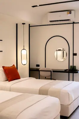 two beds sitting next to each other in a room at Pillow B Hotel in Ban Zong Katiam