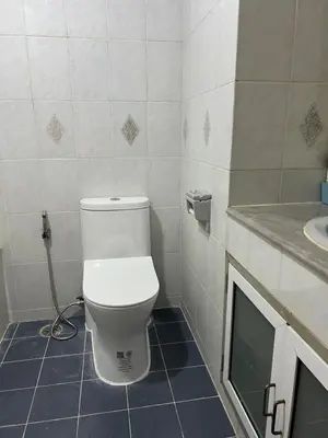 a bathroom with a toilet and a sink at Regent Srinakarin18 in Amphoe Phra Khanong