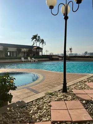 a light pole next to a swimming pool at Regent Srinakarin18 in Amphoe Phra Khanong