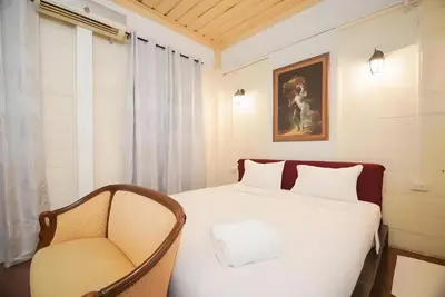 a bedroom with a bed and a chair at XX Mitr Inn Yaowarat 2 - มิตร อินน์ เยาวราช in Bangkok