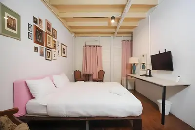 a bedroom with a white bed and a desk at XX Mitr Inn Yaowarat 2 - มิตร อินน์ เยาวราช in Bangkok